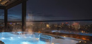 A heated terrace with a hot tub, city views, and temperature readings of 24°C/75.2°F and 38°C/100.4°F.