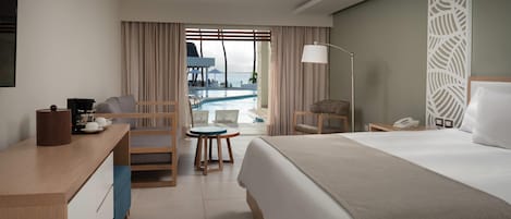 A hotel room with a bed, desk, chair, and a view of a pool.