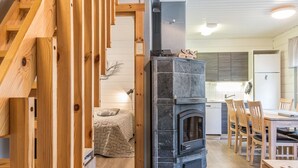 A modern kitchen with a built-in stove, wooden dining table, and chairs.