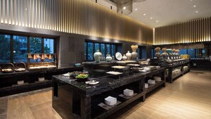 A modern hotel lobby with a long reception desk, large windows, and a decorative wall with vertical panels. - Ramada by Wyndham Hengyang Zhengxiang (Hengyang)