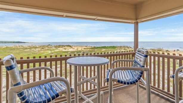 A covered outdoor seating area with a view of the beach. - Inlet Pointe Villas 14E-Oceanfront 2BR- Pool (North Myrtle Beach)