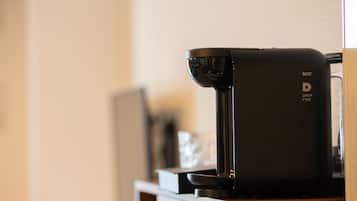 A drip coffee maker on a wooden counter.