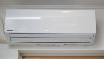 A Panasonic air conditioner mounted on a wall.