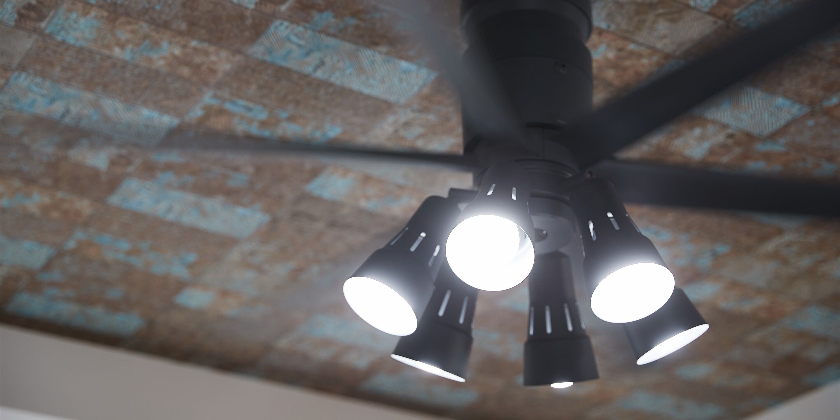 A ceiling fan with multiple light fixtures.