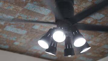 A ceiling fan with multiple light fixtures.