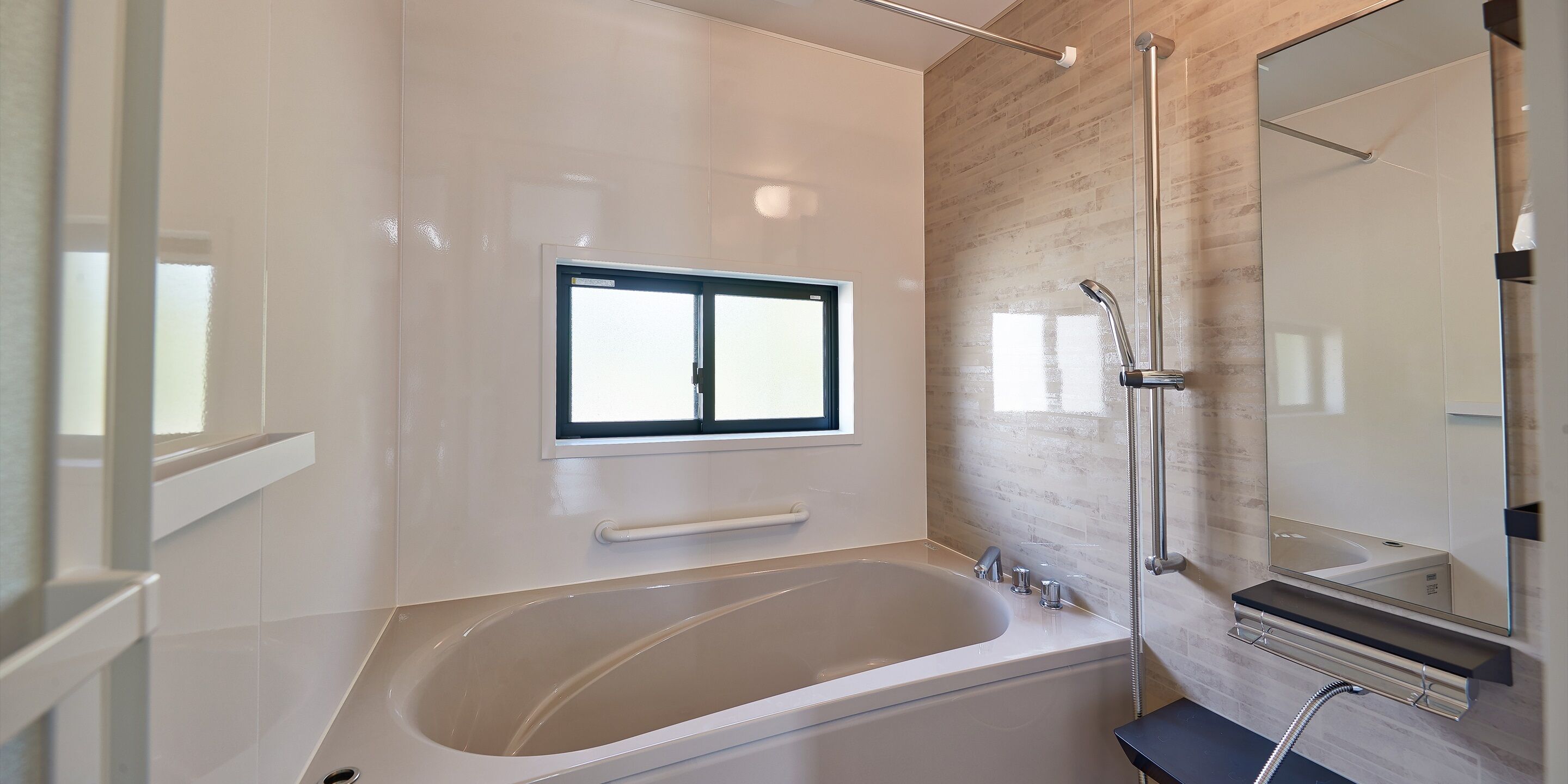 A modern bathroom with a freestanding bathtub, a glass shower enclosure, and a large mirror.