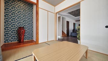 Een traditionele Japanse kamer met tatami vloerbedekking, een lage houten tafel en shoji schermen.