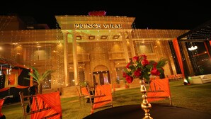 A grand building with the name "PRINCE VIRAJ" illuminated at the entrance. - Hotel Prince Viraj (Jabalpur)