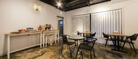 A modern kitchen with a bar area, equipped with stools and a counter.