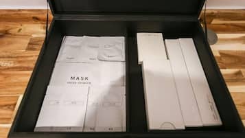 A black box containing a skincare set with labeled compartments for a mask, skin, lotion, and other items.