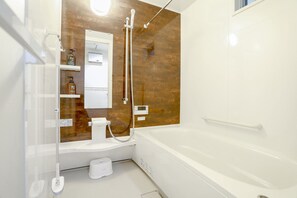 Separate tub and shower, free toiletries, hair dryer, slippers