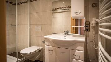 Shower, hair dryer, towels, toilet paper