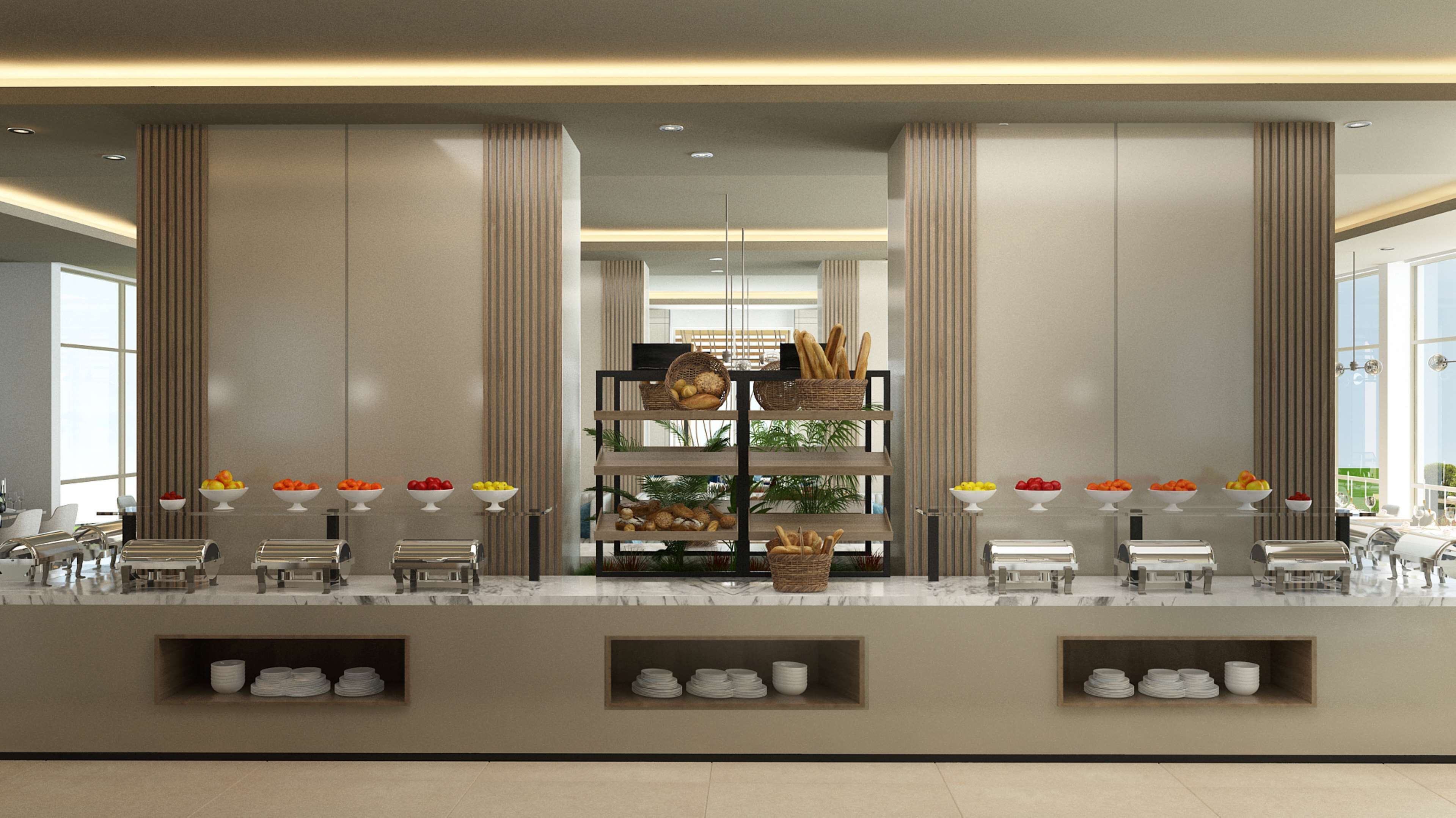 A buffet setup with multiple serving stations, a central display of bread and fruits, and a modern interior design with tall columns and a marble countertop.
