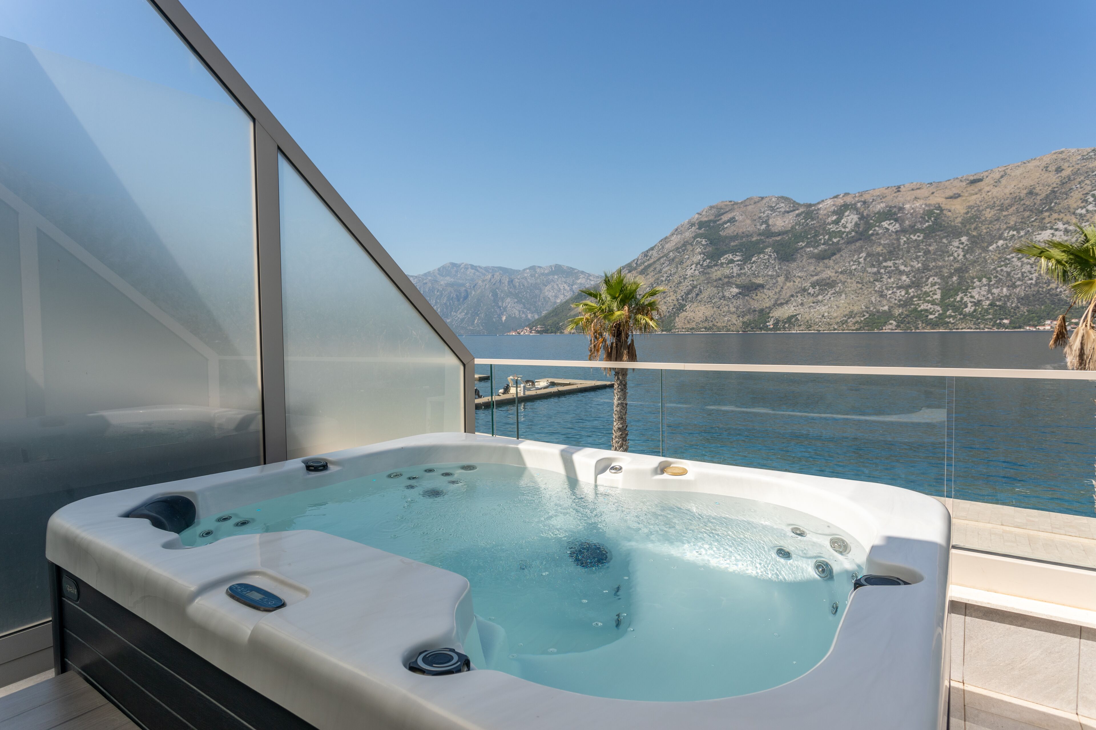 A hot tub on a balcony with a mountain view.