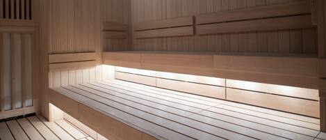 A wooden bench with a slatted design, likely part of a sauna or steam room.