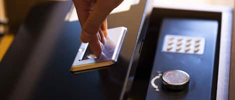 A hand interacting with a card reader on a black counter.