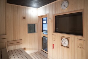 A wooden sauna room with a large window, a clock, and a bench. - Onyado Nono Kyotoshichijo Natural Hot Springs (Kyoto)