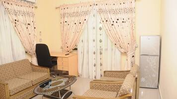 Executive Suite | Living area | 25-inch flat-screen TV with digital channels, TV