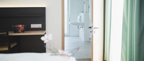 Driepersoonskamer | Een kluis op de kamer, een bureau, een laptopwerkplek