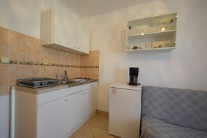 Apartment, 1 Bedroom | Private kitchen | Mini-fridge, stovetop, coffee/tea maker, cookware/dishes/utensils
