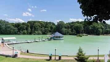 A lakeside park with a gazebo, a dock, and a walking path.