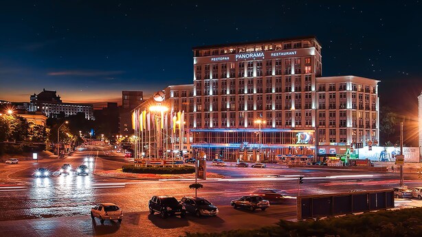 A multi-story hotel with a prominent sign reading "PECTOPAH PANORAMA RESTAURANT" at the top. - Park Hotel (Kyiv)