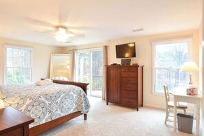 A bedroom with a bed, a dresser, a television, and a desk with a chair. - Beautiful Spacious Family Retreat w/ Pool! (Eastham)