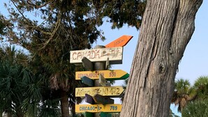 A wooden signpost with multiple directional arrows pointing to various destinations. - Family Paradise- 2bdrm/2 bath condo, indoor pool, spa, outdoor pools, & tennis. (Hilton Head Island)