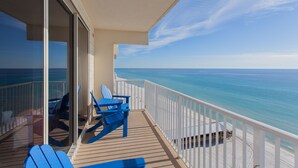 A balcony with a view of the ocean, blue chairs, and a white railing. - Beautiful Beachfront 11th Floor Condo w/ Direct Gulf Views Panama City Beach, FL (Shores of Panama, Panama City Beach)