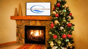 A fireplace with a stone mantle, a Christmas tree with ornaments, and a framed sign above the fireplace. - ❤️Great WiFi. Beautiful Home for a Ski Getaway. 15% off of ski rentals  (Snowshoe)