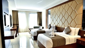 A hotel room with a large bed, a desk, and a chair. - Be Inn Hotel (Seeb)