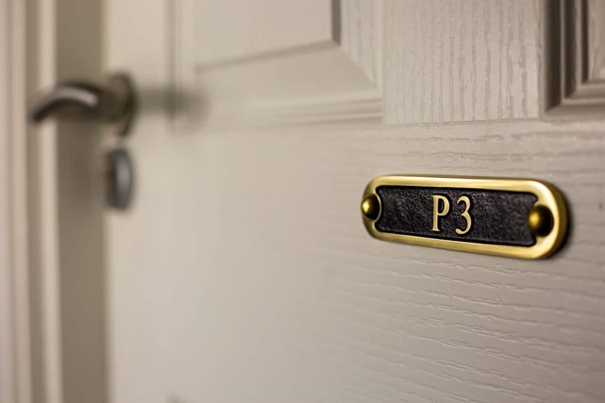 A door with a brass plate labeled "P3" and a keyhole.