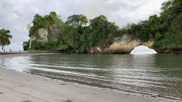 A beach with a natural rock formation and a sandy shore. - Colón Plaza Hotel (Tumaco)