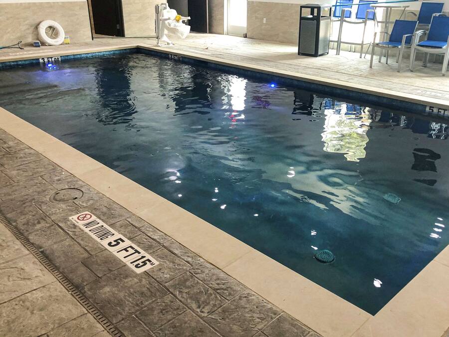 Indoor pool, open 10:00 AM to 10:00 PM, pool loungers