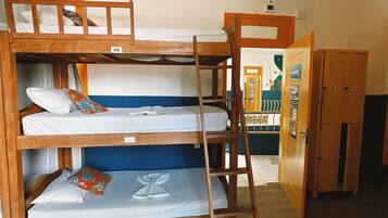 A bunk bed with three levels, wooden lockers, and a ladder.