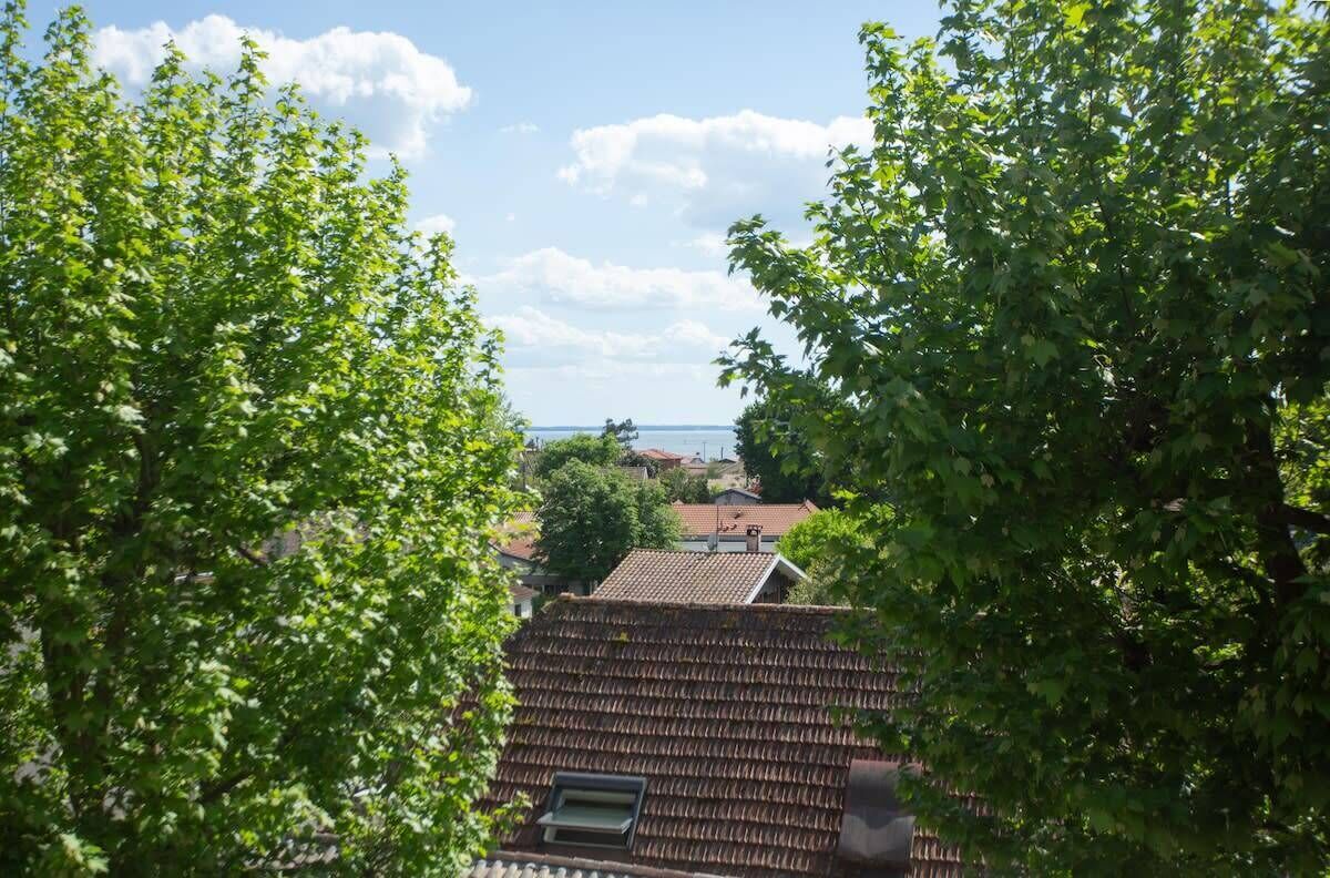 A view of a residential area with a house featuring a tiled roof and a small window.