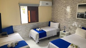 A hotel room with two single beds, a large window, an air conditioning unit, and a tiled floor.