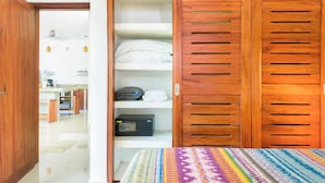 A room with a bed, a wardrobe with multiple shelves, and a radio. - Nestled in the heart of Tulum town, steps away from Tulum's most lively street (Tulum)
