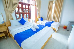 Deluxe Triple Room, City View | Minibar, in-room safe, desk, laptop workspace - TiMee Hotel & Apartment (Nha Trang)
