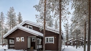 A wooden cabin surrounded by snow-covered trees. - Albatrossi by Interhome (Kittilä)