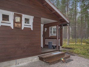 A wooden cabin with a porch, a small window, and a mailbox. - Albatrossi by Interhome (Kittilä)