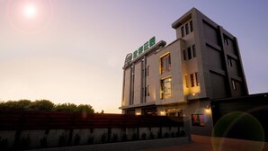 A modern building with a sign that reads "Green Hotel." - K-1 Hotel (Yuanlin)