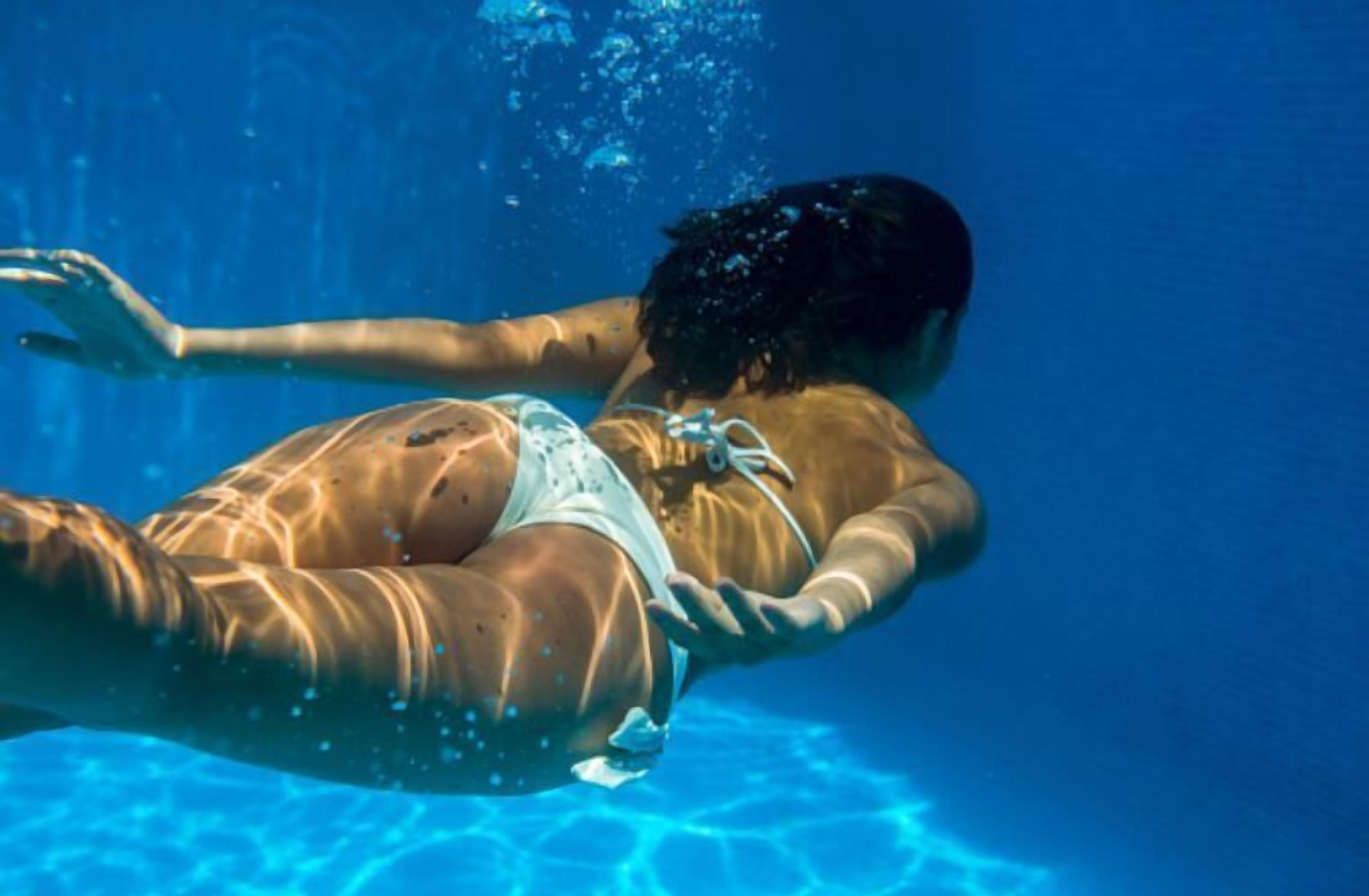A person swimming underwater.
