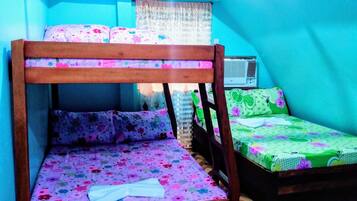 A room with a bunk bed, a window with a view, and a radiator.