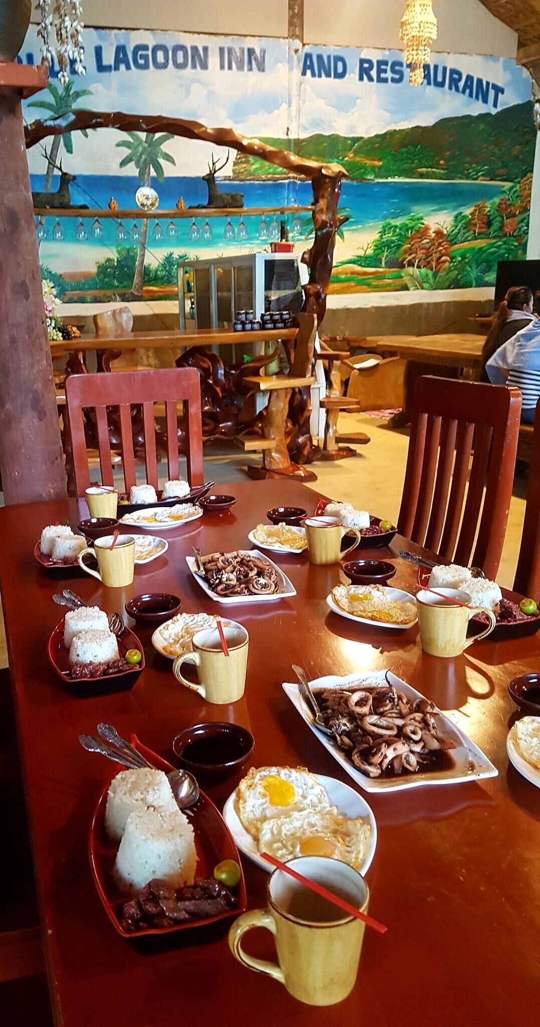 A dining table at Lagoon Inn and Restaurant with various dishes and drinks.