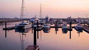 A marina with multiple boats docked at wooden piers. - Parkside Plaza Hotel - Muscat (Muscat)