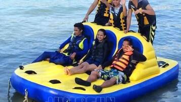 A group of people on a blue and yellow inflatable raft.