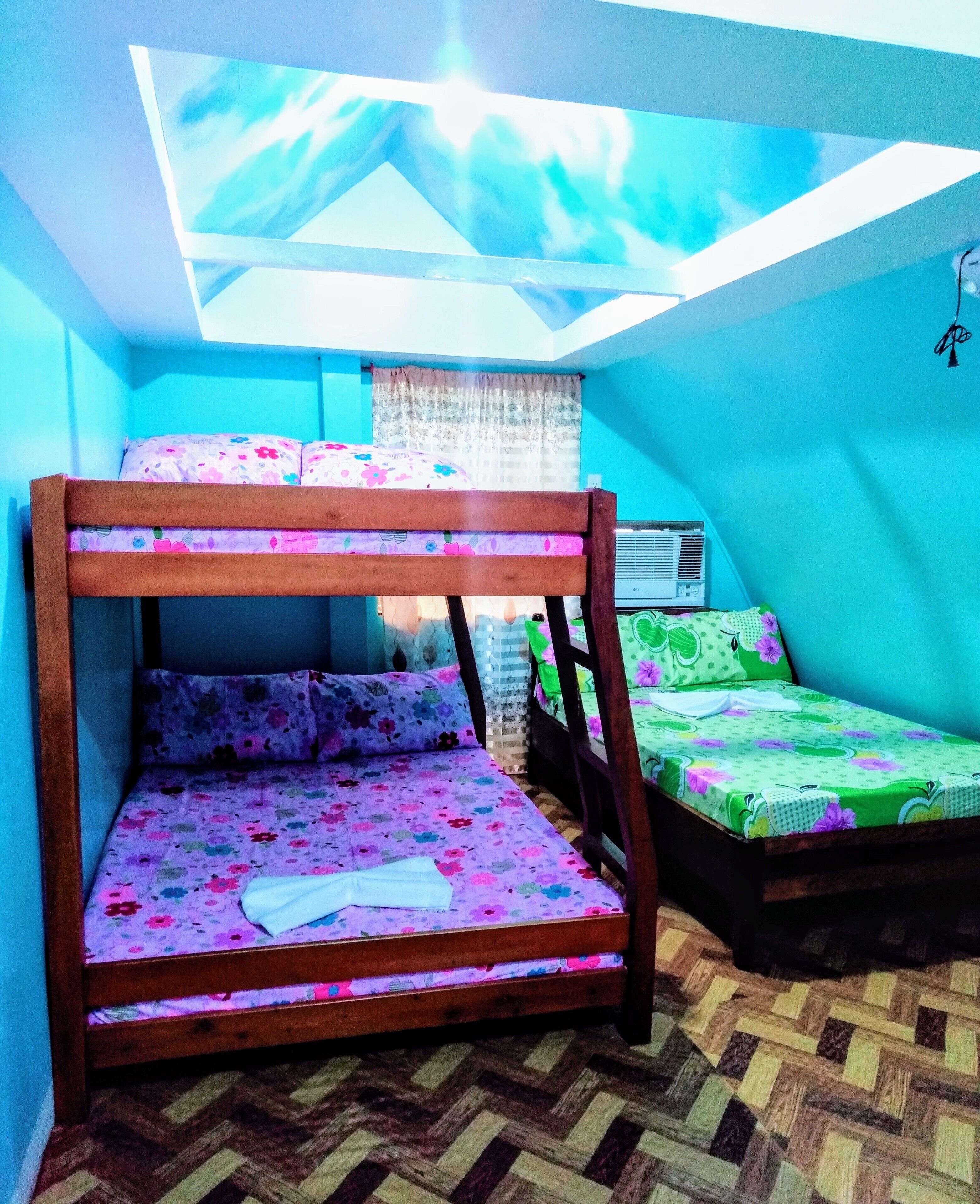 A room with a bunk bed, a window with a view, and a radiator.