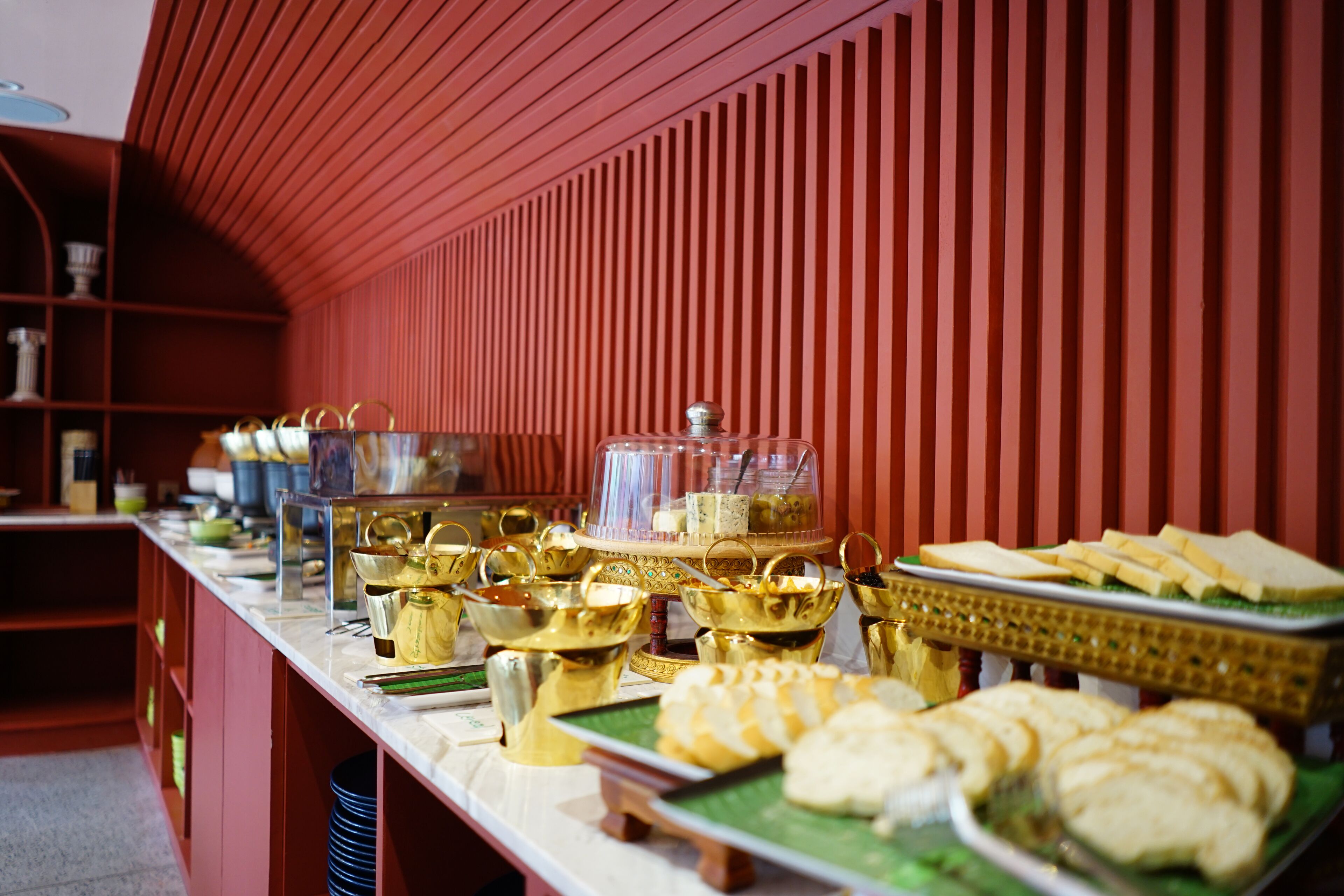 A buffet setup with various food items and serving dishes.