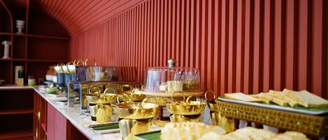 A buffet setup with various food items and serving dishes.